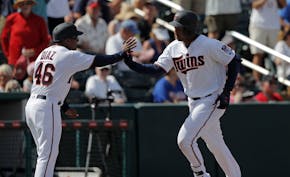 The Twins' Jonathan Schoop was greeted by third base coach Tony Diaz while rounding third base on his two-run home run in the fifth inning of a spring