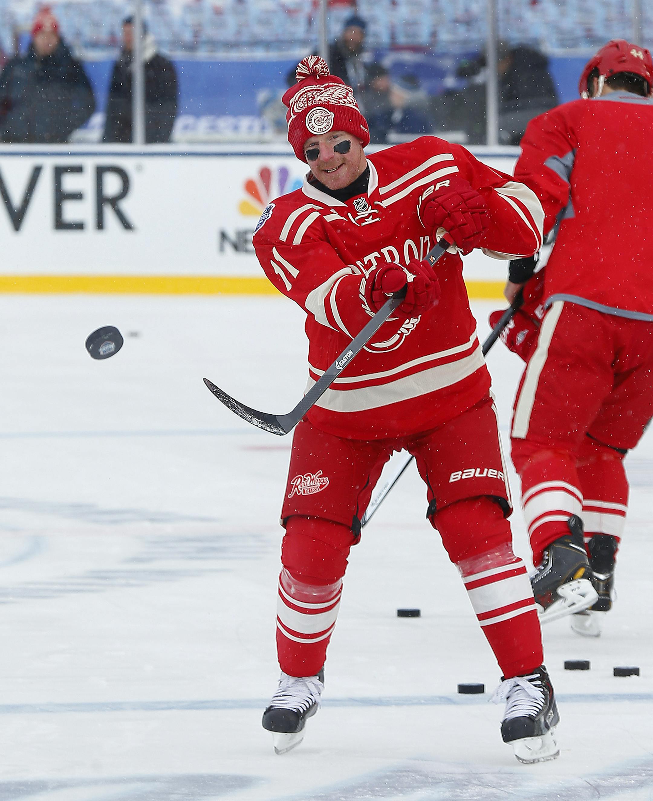 Detroit Red Wings right wing Daniel Alfredsson (11), of Sweden, shoots a puck during practice on the outdoor rink for the NHL Winter Classic hockey game against the Toronto Maple Leafs at Michigan Stadium in Ann Arbor, Mich., Tuesday, Dec. 31, 2013. The game is scheduled for New Year's Day. (AP Photo/Paul Sancya)