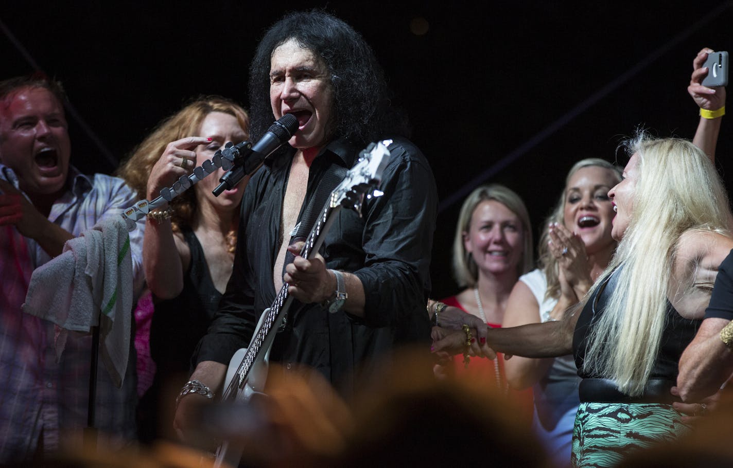 Members of the crowd came on stage with Kiss (Gene Simmons in this picture) as they performed their final song "I'm wanna to Rock N Roll all night" during a charity concert at philanthropist Martha "Muffy" MacMillan's home on Tuesday, August 2, 2016, in Long Lake, Minn.] RENEE JONES SCHNEIDER &#x2022; renee.jones@startribune.com