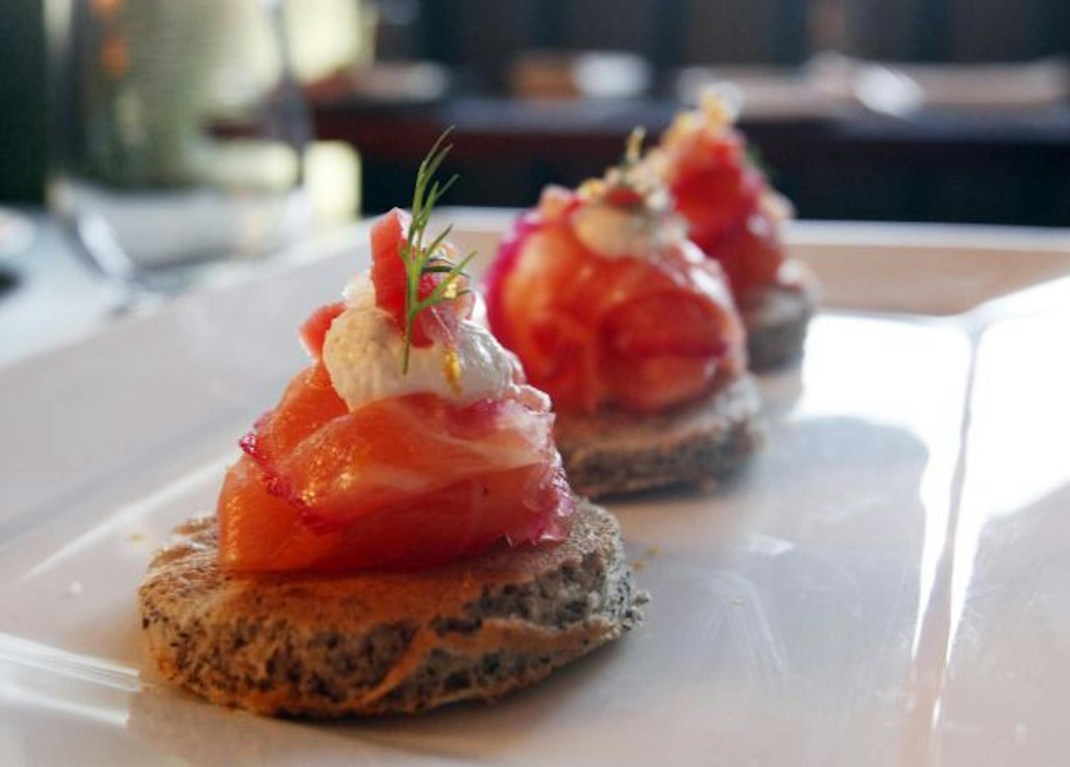 Cured salmon, garnished with Chioggia beets and horseradish creme fraiche.