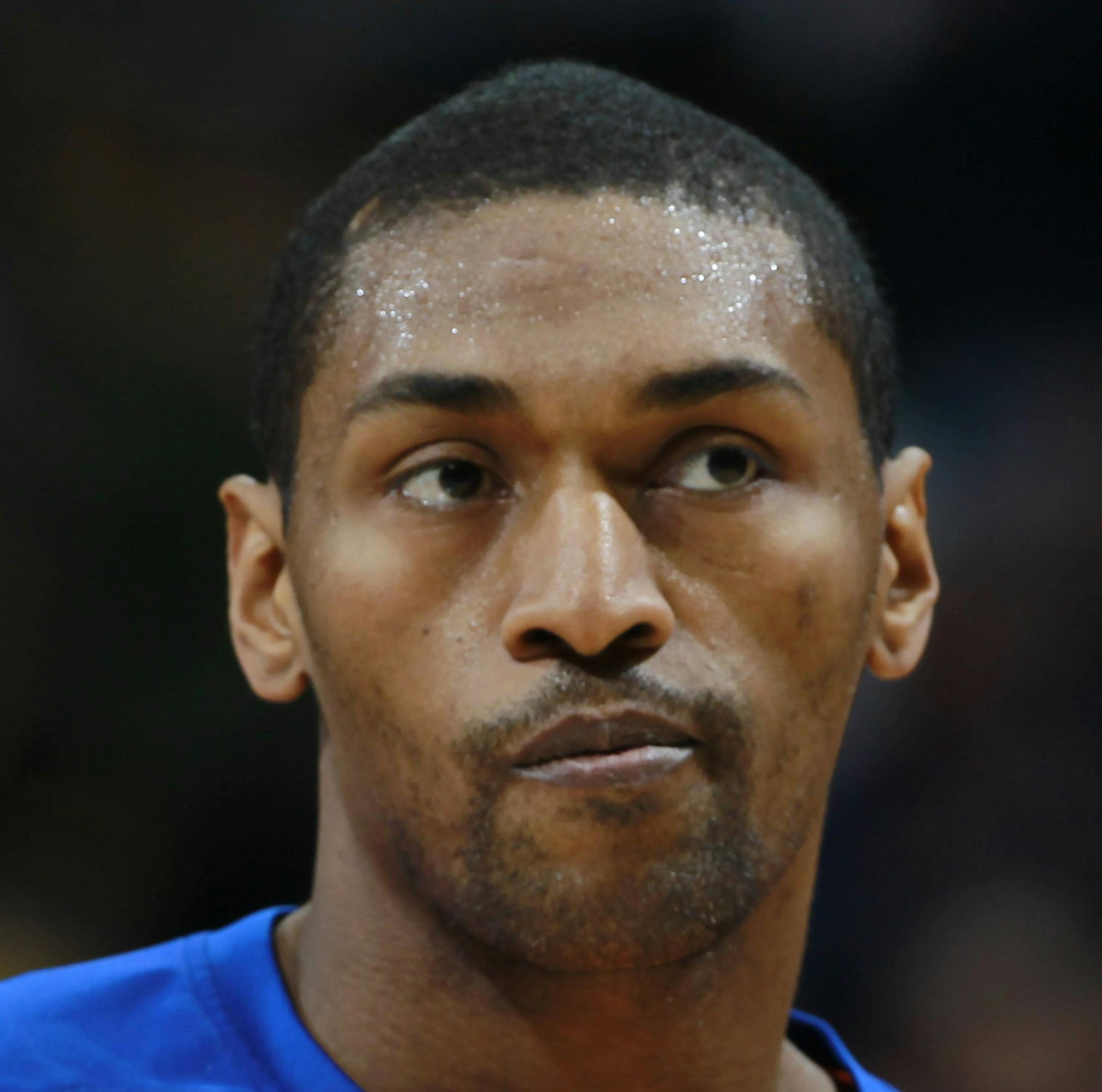 New York Knicks forward Metta World Peace warms up before facing the Denver Nuggets in the first quarter of an NBA basketball game in Denver on Friday, Nov. 29, 2013. (AP Photo/David Zalubowski) ORG XMIT: MIN2014010219383162