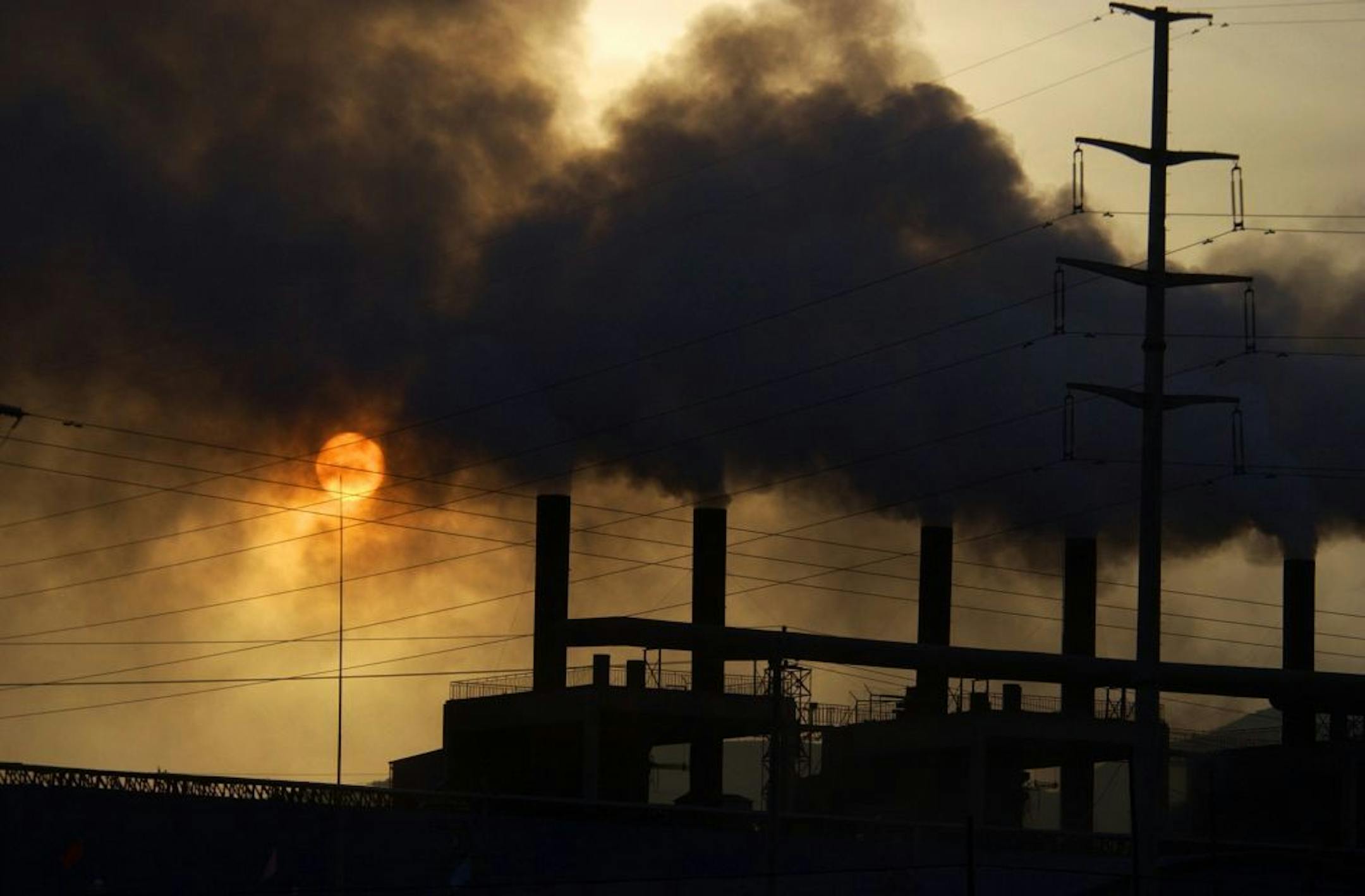 Clouds of smoke billow from a metal alloy factory in Gaolan county in northwest China's Gansu province Tuesday Nov. 7, 2006. The International Energy Agency said Tuesday that China is expected to overtake the United States as the world's biggest emitter of carbon dioxide before 2010.
