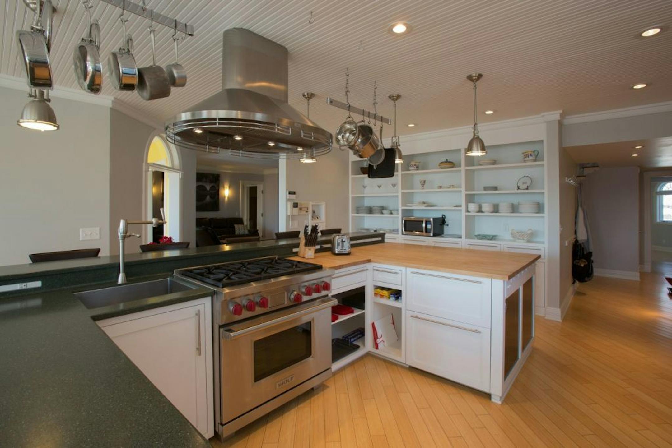 The kitchen has high-end appliances and a breakfast bar.