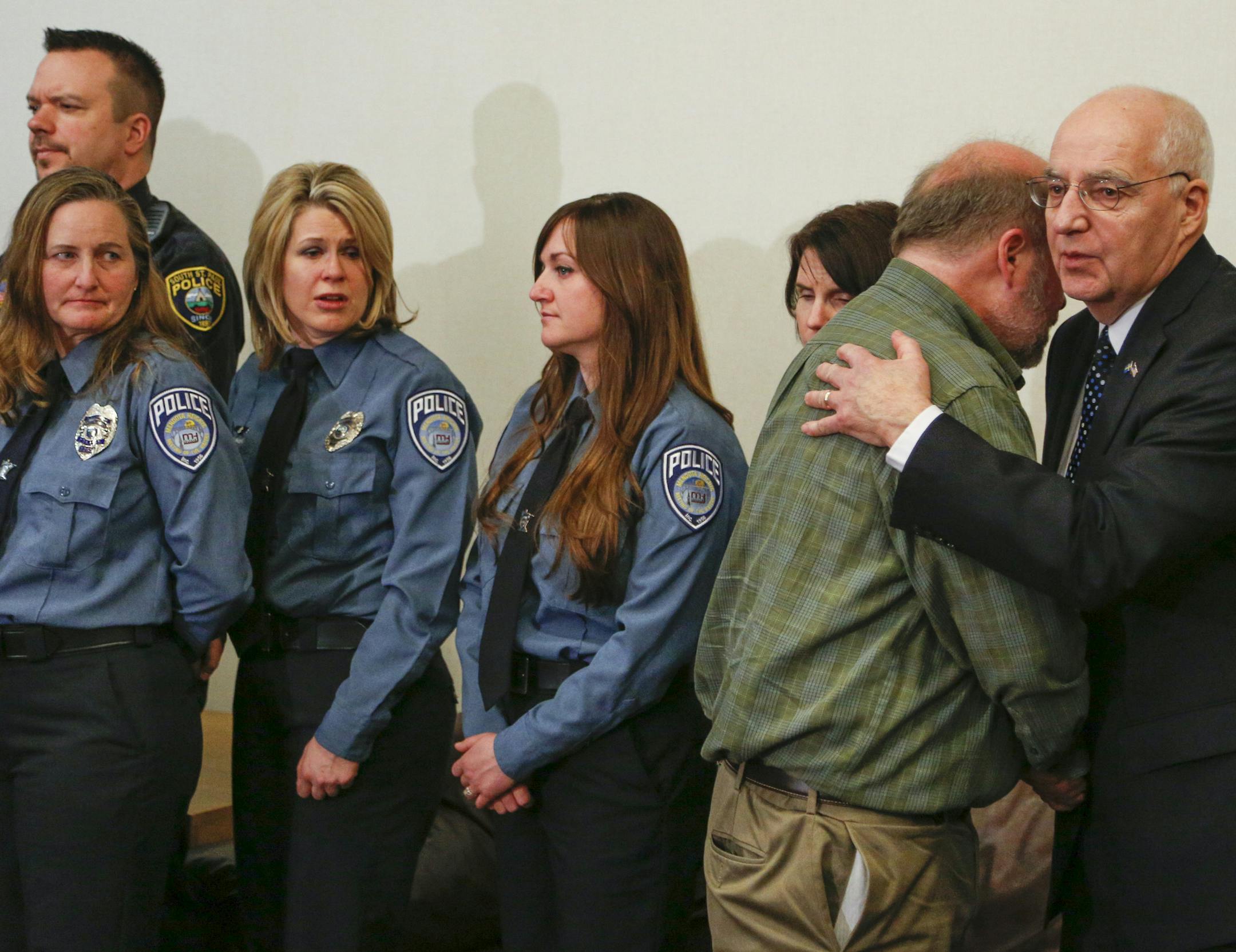 Officer Scott Patrick's brother, Mike Brue, gets a hug from Dakota County Attourney James Backstrom after the sentencing of Brian Fitch in the death of his brother. ] BRIAN PETERSON ‚Ä¢ brianp@startribune.com Hastings, MN - 2/4/2015