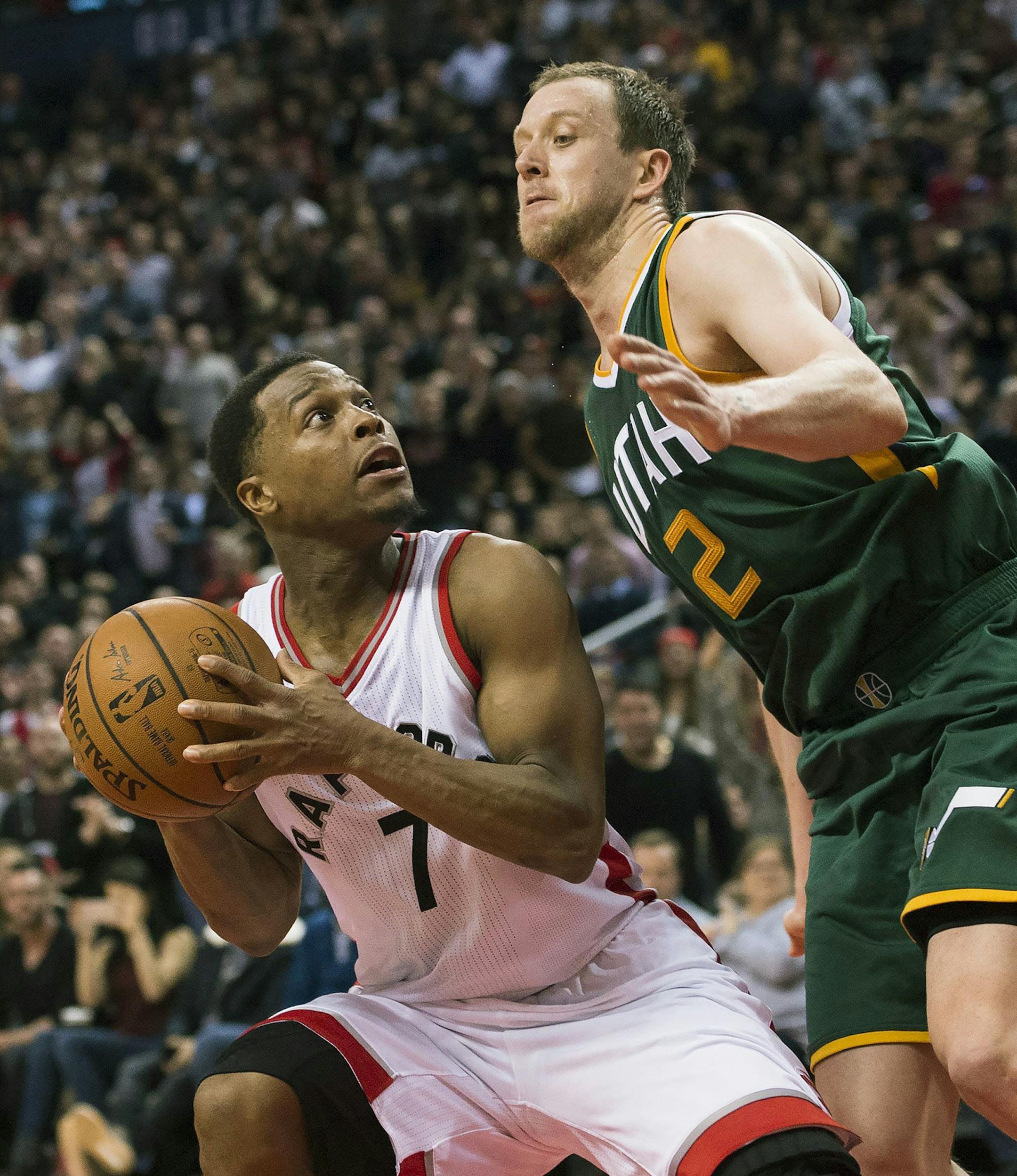 Toronto Raptors guard Kyle Lowry (7) battles against Utah Jazz forward Joe Ingles (2) during the second half of an NBA basketball game, Thursday, Jan. 5, 2016 in Toronto. (Nathan Denette/The Canadian Press via AP)