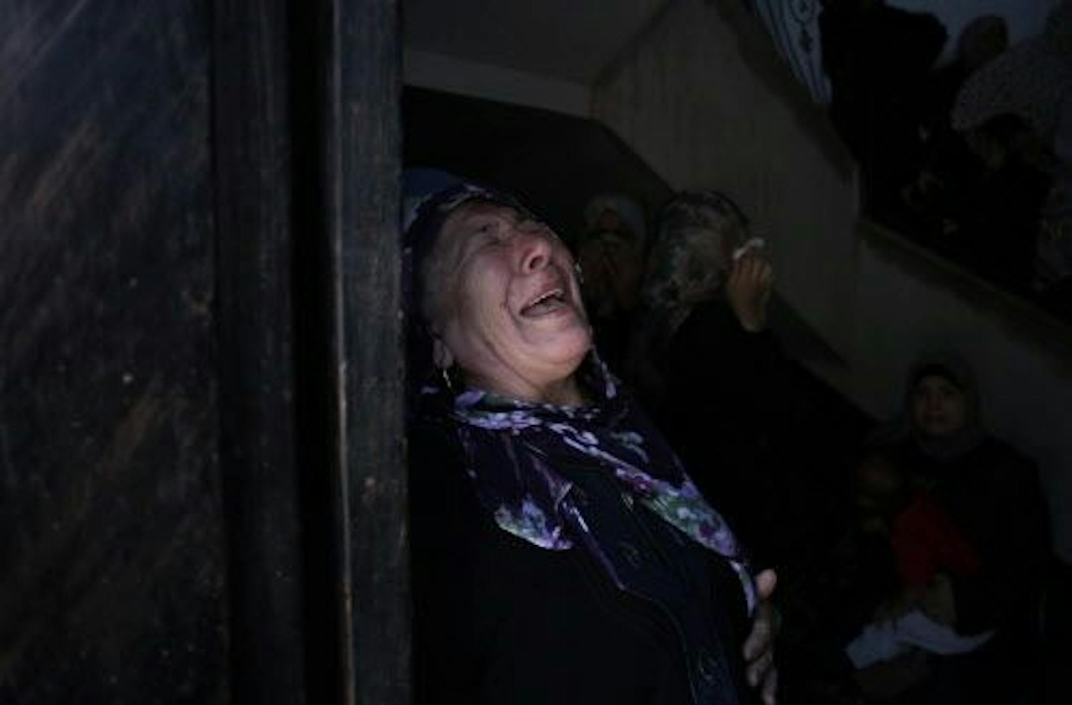 A Palestinian relative of the five members of the Hamad family who were killed in an Israeli missile strike late Tuesday grieves in the family house during their funeral in town of Beit Hanoun, northern Gaza Strip, Wednesday, July 9, 2014.