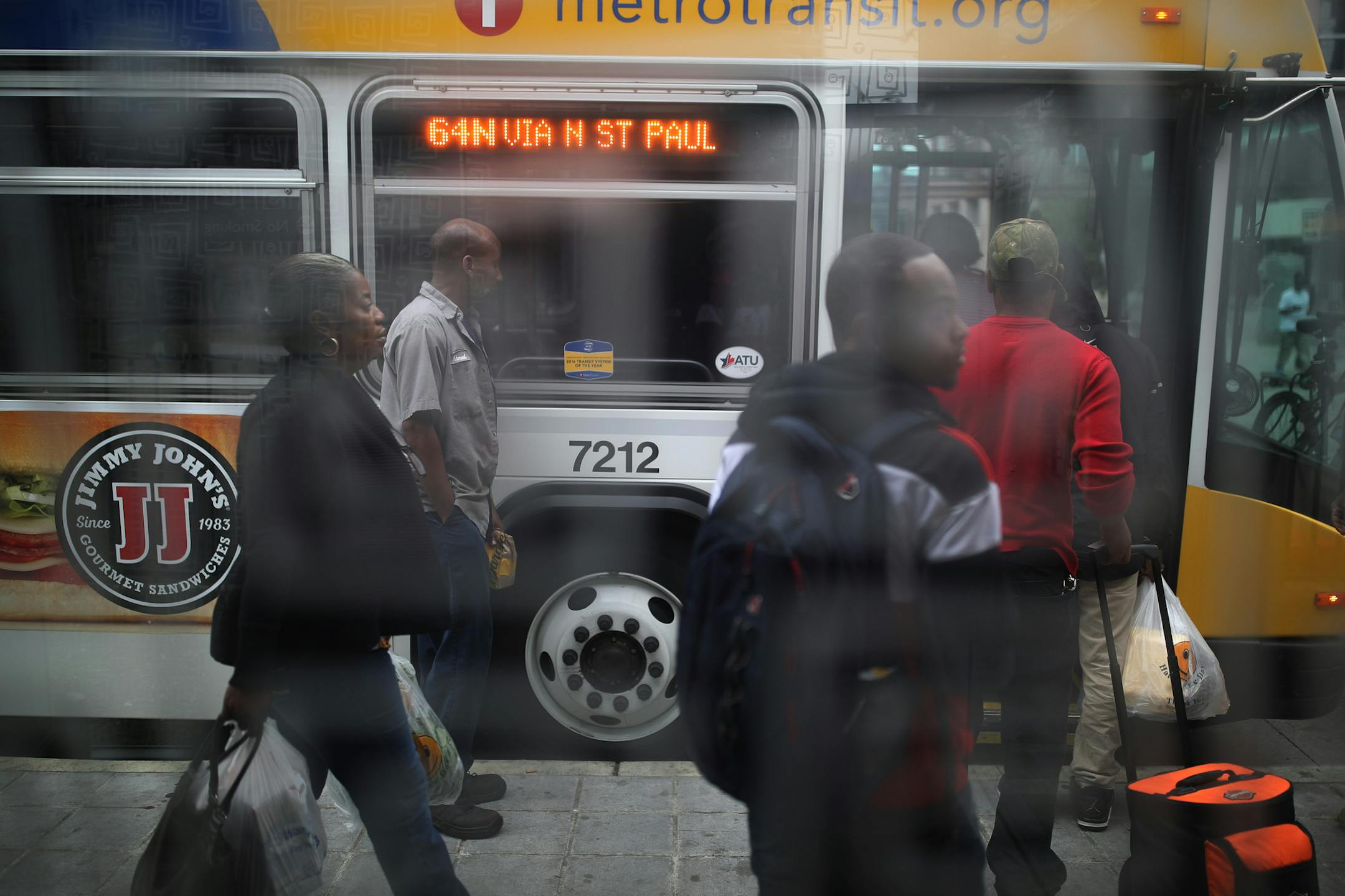 People boarded a bus as ukulele instrumentalist Marlowe Teichman played at Central Station block during the lunch hour Wednesday August 9, 2017 in St. Paul, MN. ] JERRY HOLT ï jerry.holt@startribune.com