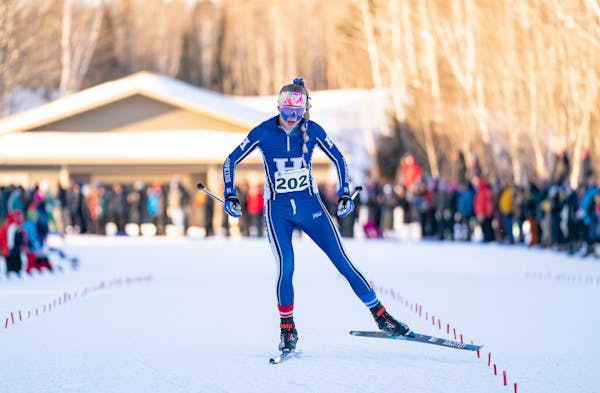 Hopkins skier Sydney Drevlow crosses the finish line of the girls 5k freestyle pursuit race to win the gold medal at the Minnesota State High School L