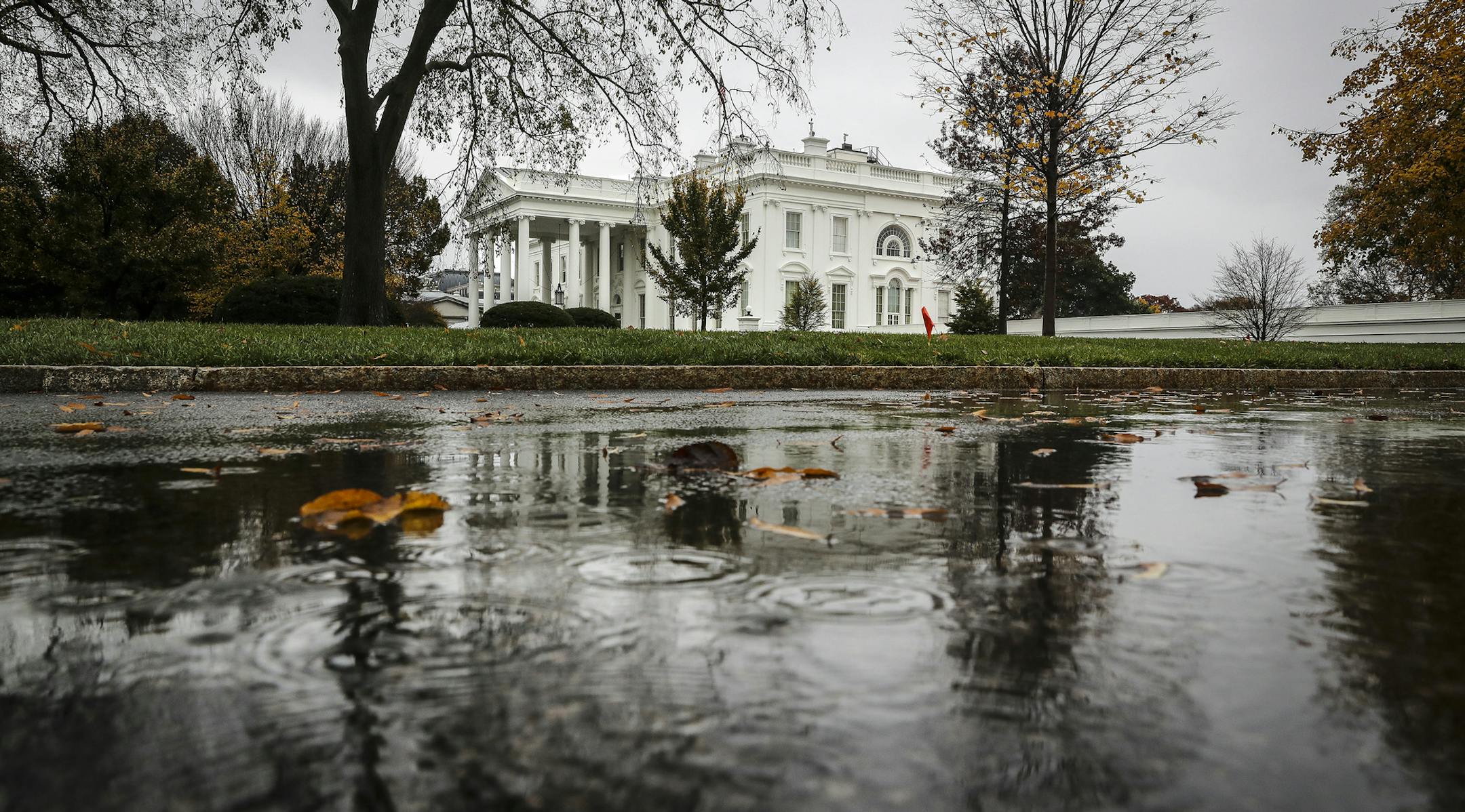 The White House is reflected in a puddle, during a rain in Washington, on Thursday, Nov. 12, 2020. It's not exactly a stampede, but the number of Republicans willing to acknowledge President-elect Joe Biden's victory is growing, with Gov. Mike DeWine of Ohio and the veteran party operative Karl Rove, who served as an adviser to the Trump campaign, urging the president to accept defeat. (Oliver Contreras/The New York Times)