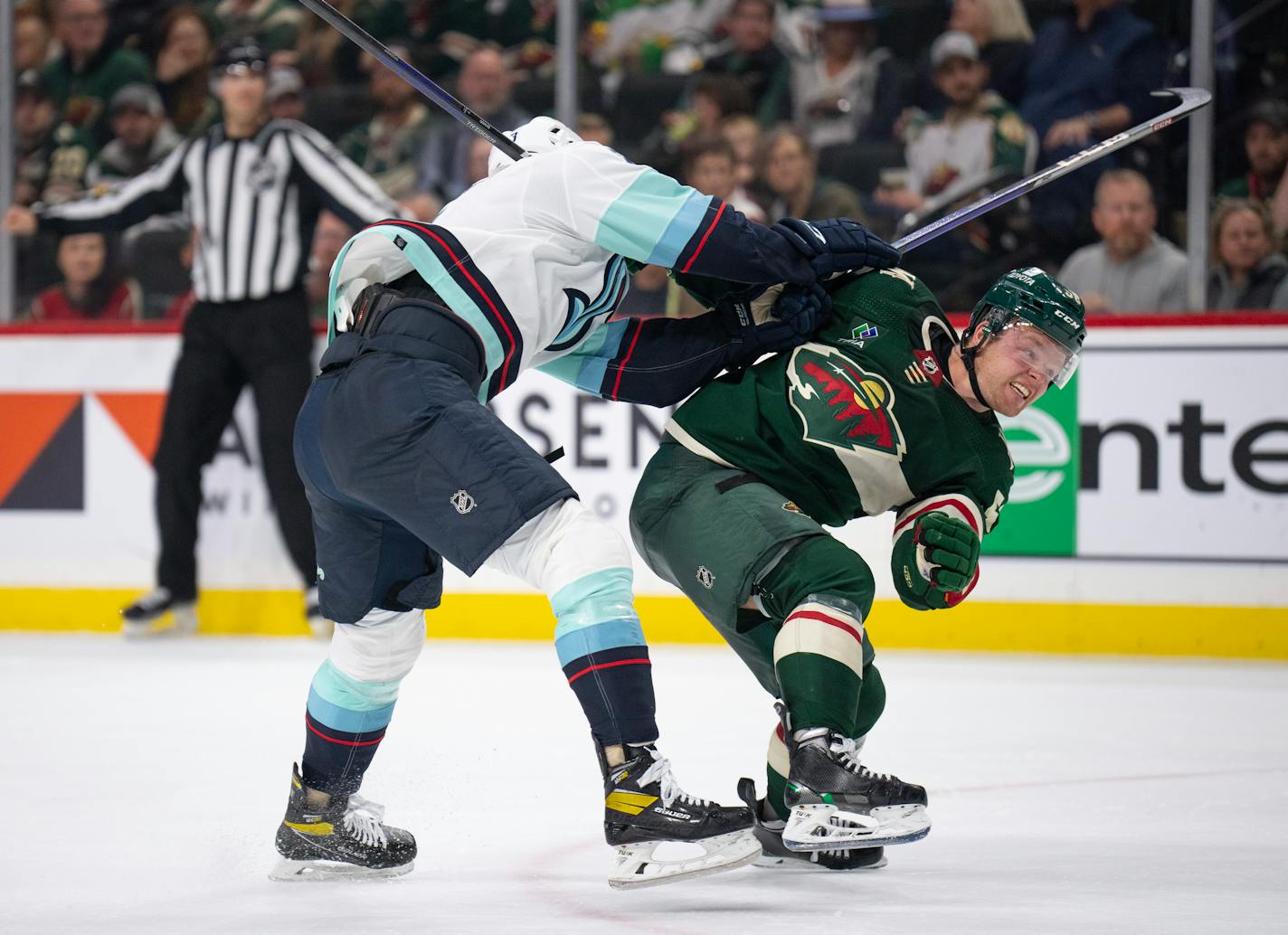 Minnesota Wild center Mason Shaw (58) is checked from behind by Seattle Kraken defenseman Will Borgen (3) in the third period.