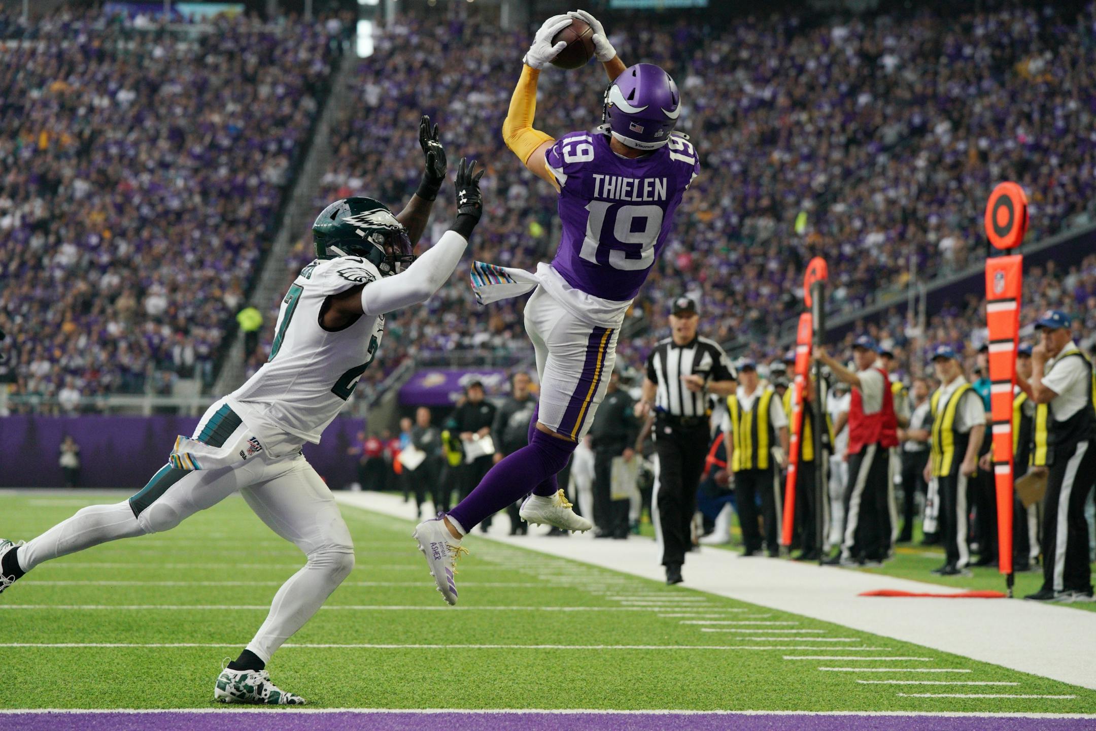 Minnesota Vikings wide receiver Adam Thielen (19) went up to catch a pass from Minnesota Vikings quarterback Kirk Cousins (8) but was pushed out of bounds by Philadelphia Eagles strong safety Malcolm Jenkins (27) in the first quarter.