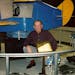 Curtis Erickson is shown with the Link trainer that he used to train commercial airline pilots on flying by instrument.