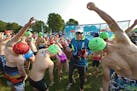 Young triathletes limbered up before the start of the race at Lake Elmo Park Reserve as Bob Powers looked on. At 91, Powers is the nation�s oldest t