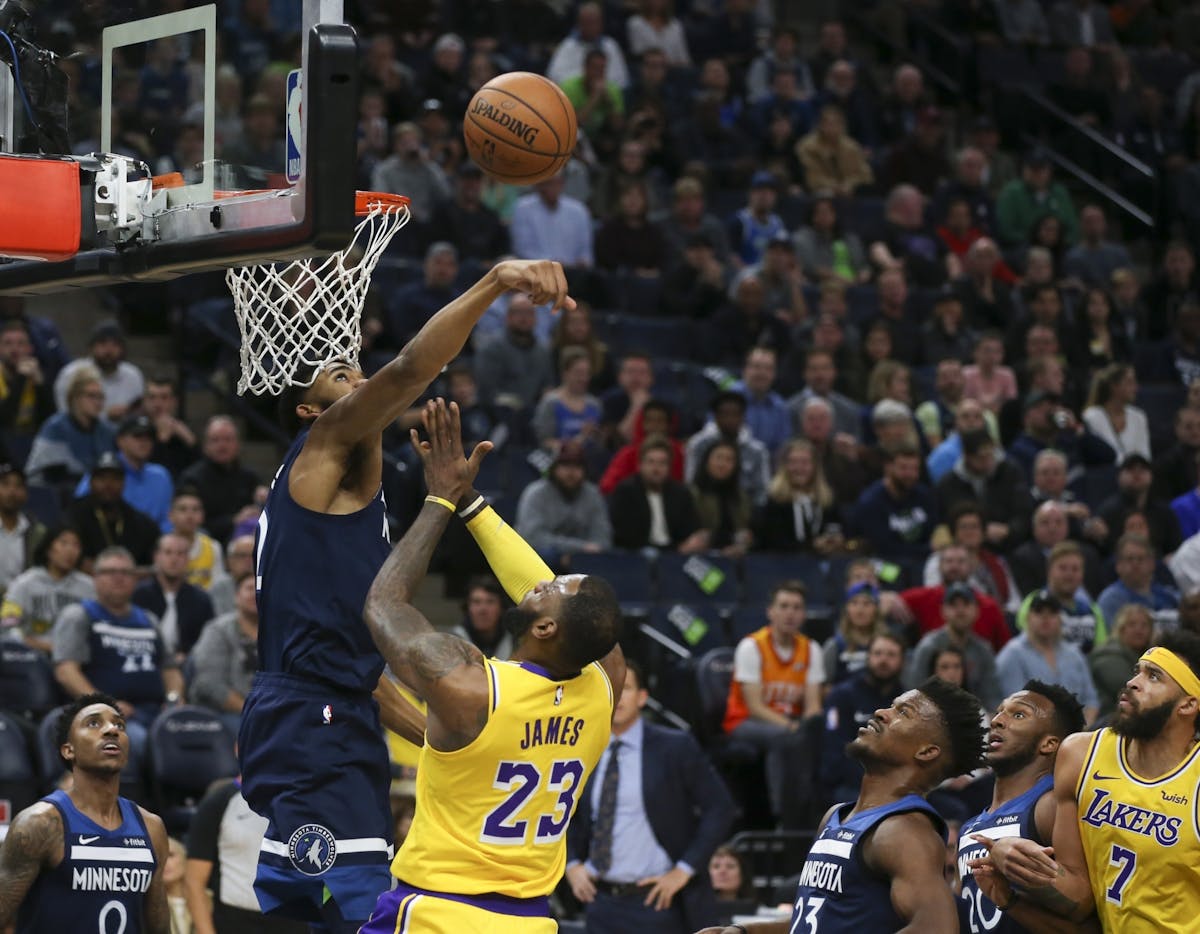 Minnesota Timberwolves center Karl-Anthony Towns (32) swatted away a first half shot by Los Angeles Lakers forward LeBron James (23).