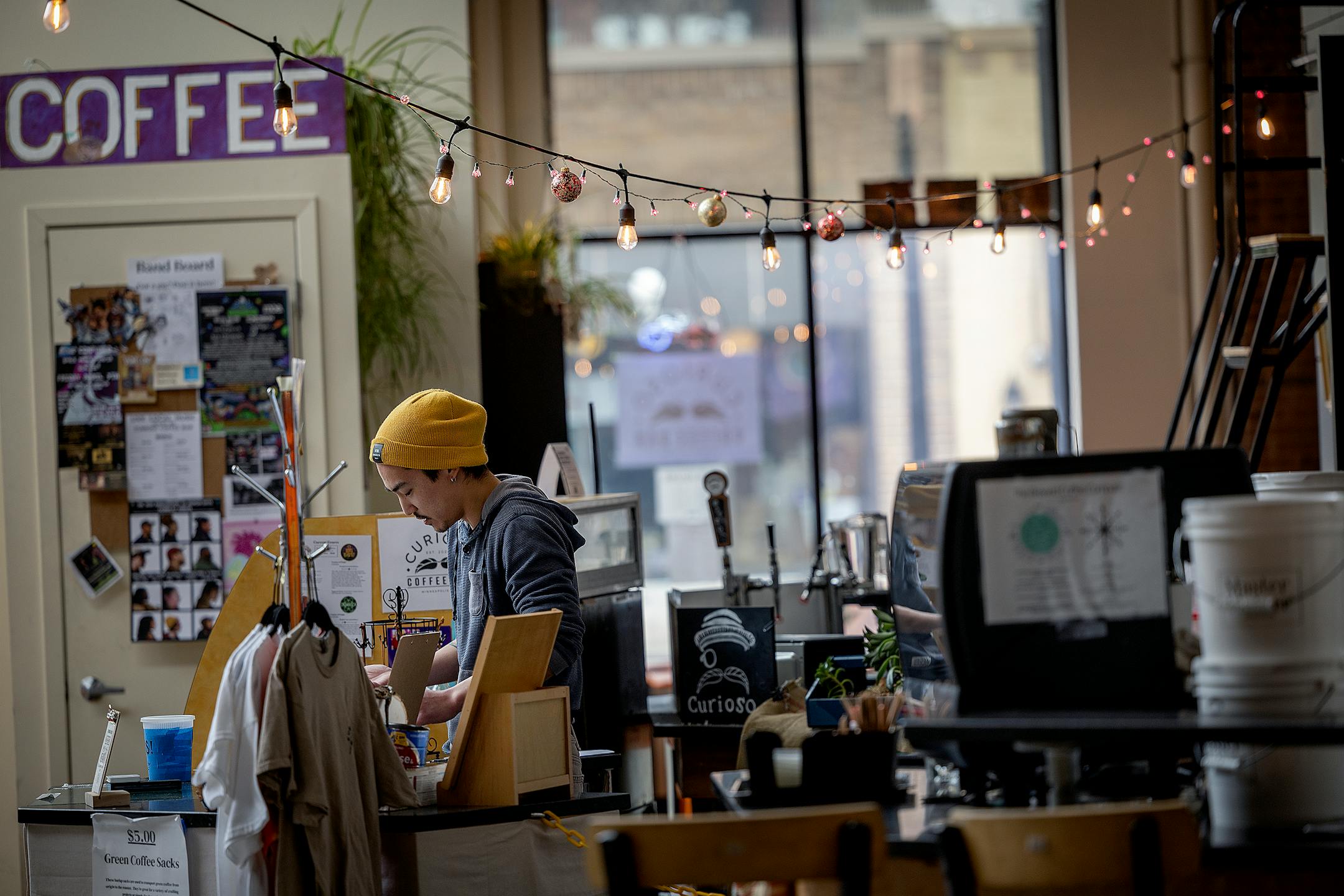 Aaron Blaser, the CEO and Roaster of Curioso Coffee &amp; Libations, tends to a customer at the Seven Points retail center in Minneapolis, Minn., on Wednesday, March 22, 2023.