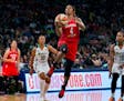 Washington Mystics' Tayler Hill goes up for two points as she drives past New York Liberty's LaToya Sanders (30) and Epiphanny Prince, right, in the s