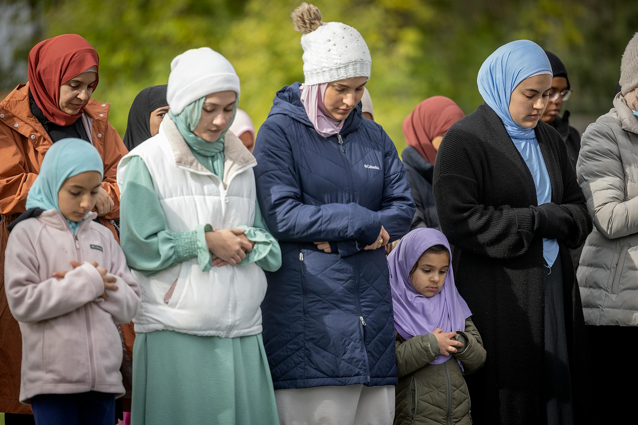 Female Muslims pray during the Salaatul Kusoof during a viewing party of the annular Eclipse at Commons Park in Fridley, Minn., on Saturday, Oct. 14, 2023. The Salatul Kusoof is a prayer in the Muslim faith known as the "eclipse prayer," which occurs when the moon comes between the sun and Earth.