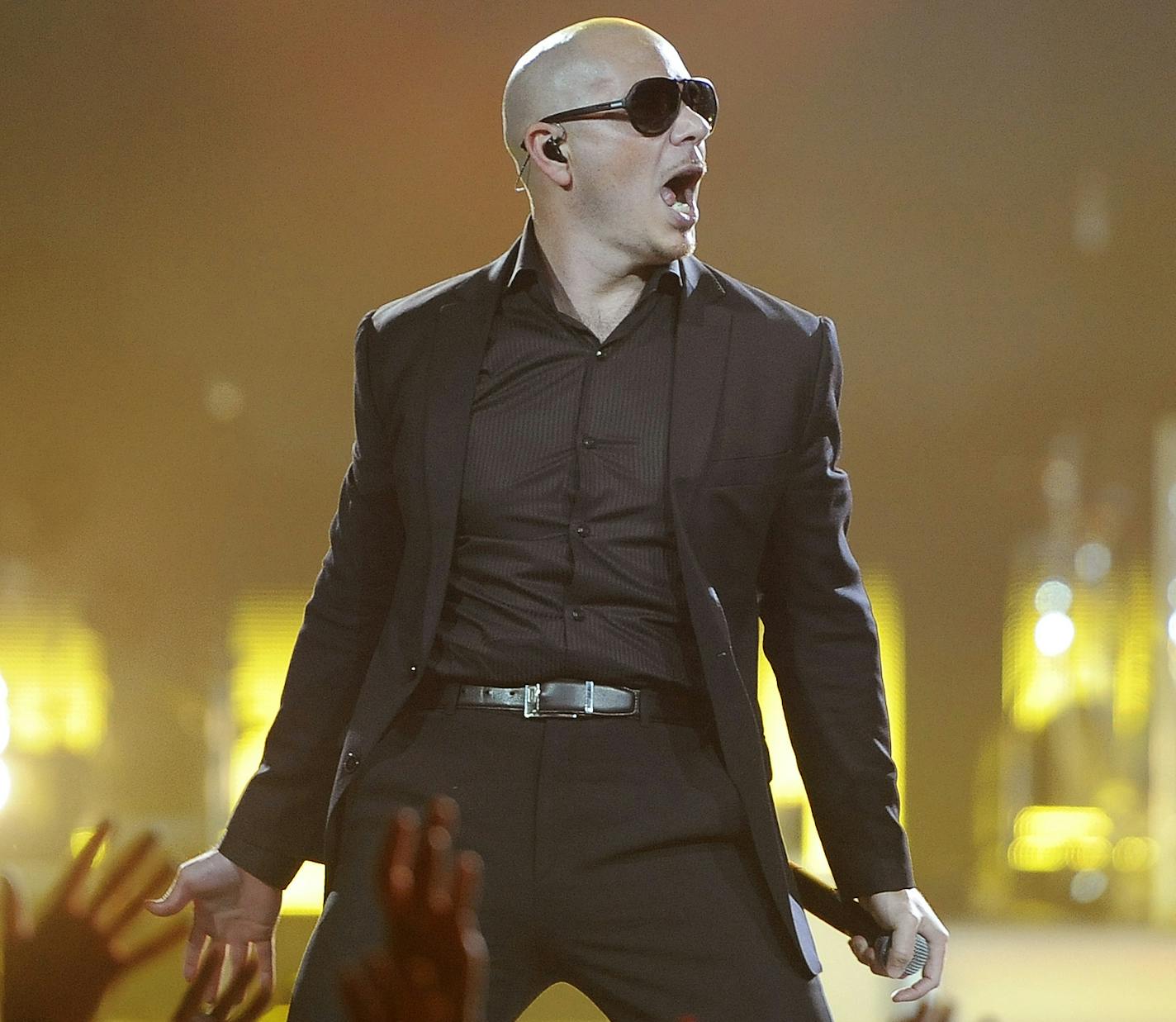 Enrique Iglesias, right, is joined onstage by guest performer Pitbull at the Honda Center on Saturday, Aug. 11, 2012 in Anaheim, Calif. (Photo by Chris Pizzello/Invision/AP) ORG XMIT: INVW