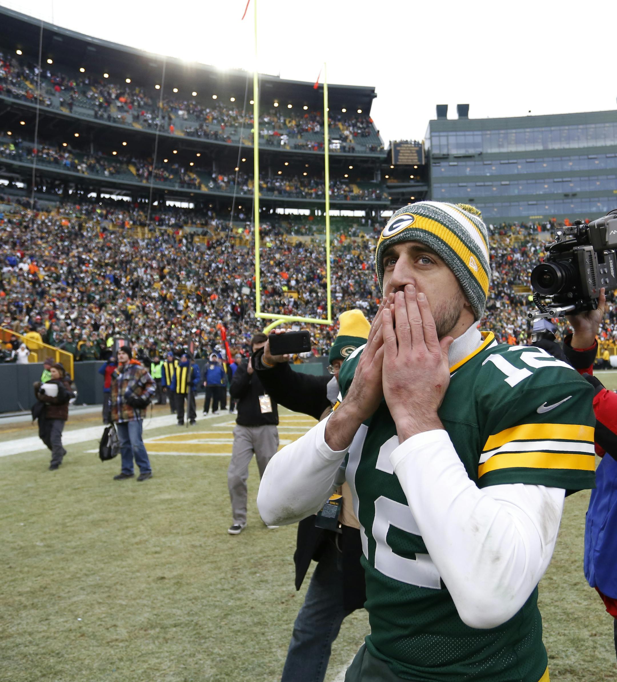 Green Bay Packers quarterback Aaron Rodgers blows a kiss to fans after an NFL divisional playoff football game against the Dallas Cowboys Sunday, Jan. 11, 2015, in Green Bay, Wis. The Packers won 26-21. (AP Photo/Matt Ludtke)