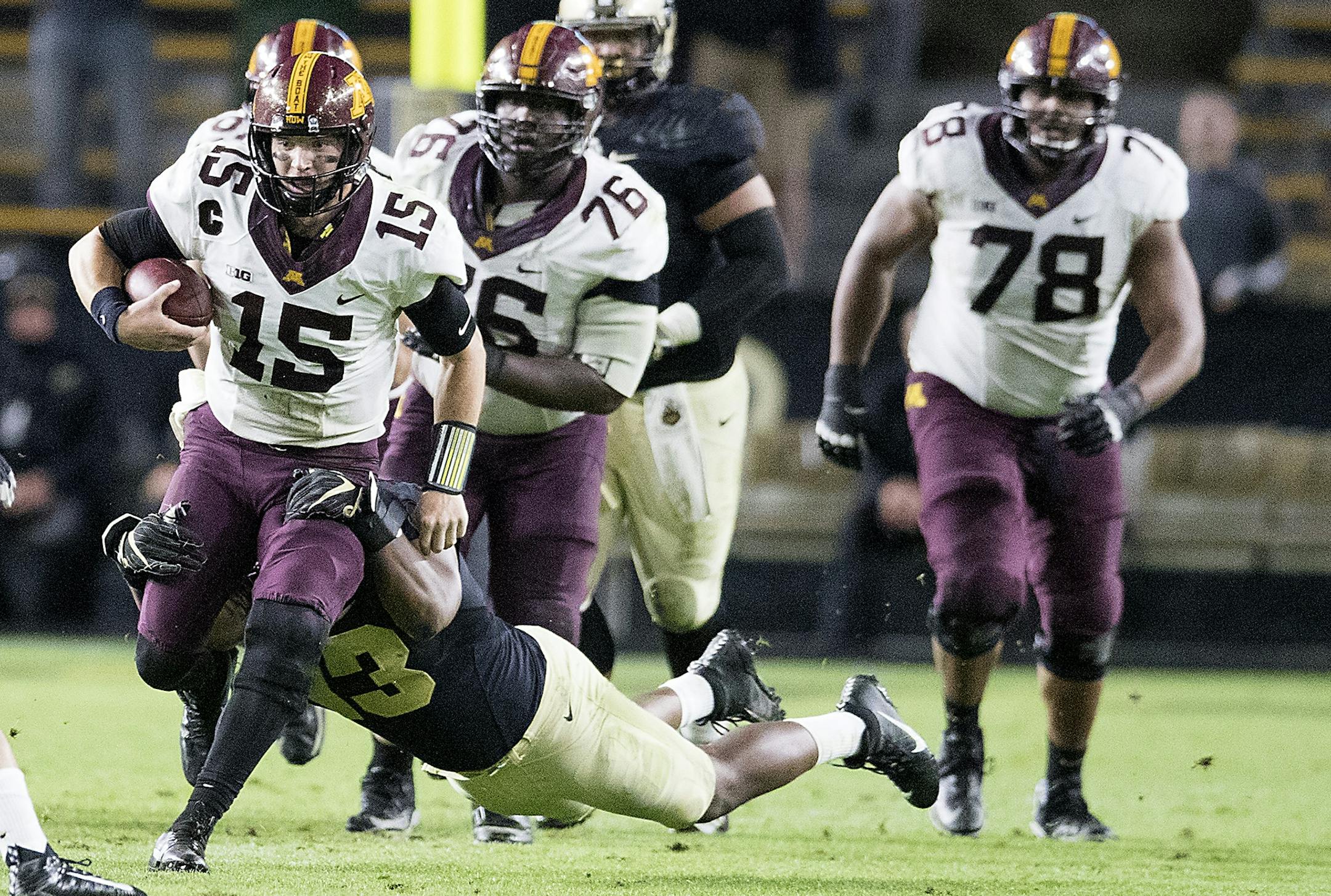 Minnesota's quarterback Conor Rhoda is taken down by Purdue's defensive end Gelen Robinson during the fourth quarter the Gophers took on Purdue at Ross�Ade Stadium, Saturday, October 7, 2017 in West Lafayette, IN.