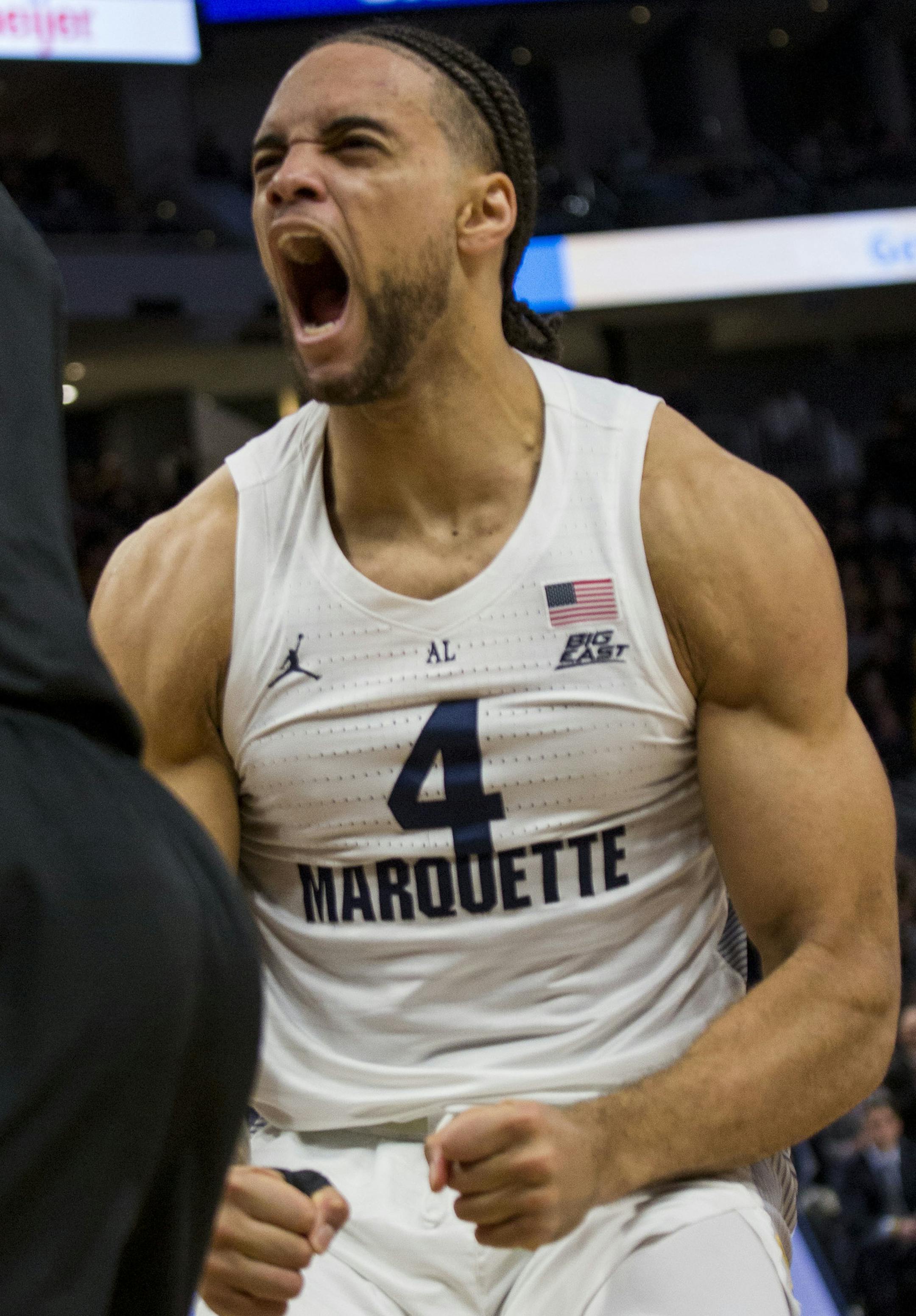 Marquette forward Theo John, right, shouts after a dunk against Buffalo guard CJ Massinburg, left, during the first half of an NCAA college basketball game Friday, Dec. 21, 2018, in Milwaukee. John was called for taunting. (AP Photo/Darren Hauck)