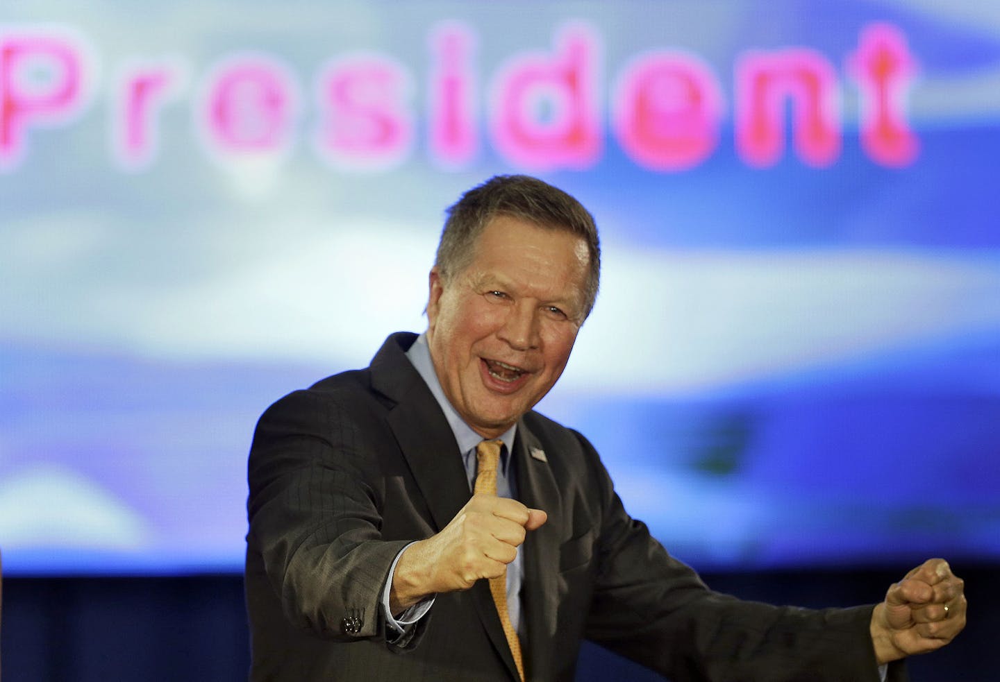 Republican presidential candidate Ohio Gov. John Kasich pumps his fist and celebrates before speaking at his presidential primary election rally in Berea, Ohio, on Tuesday, March 15, 2016. Kasich won Ohio in the primary. (AP Photo/Tony Dejak) ORG XMIT: MIN2016031811274821