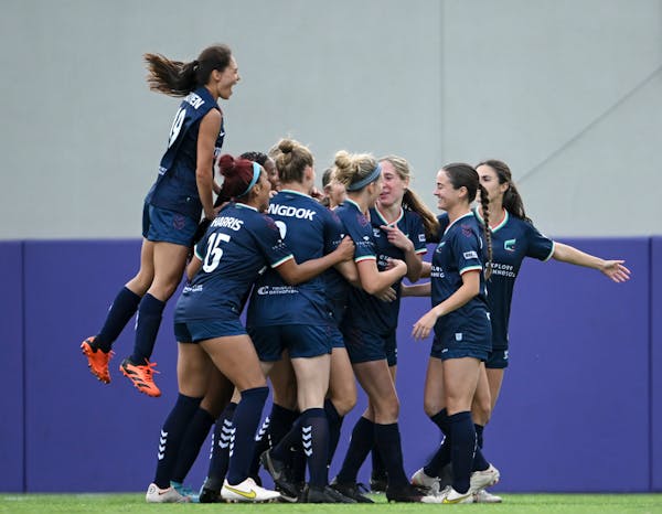 Teammates celebrate with Minnesota Aurora forward Catherine Rapp after she scored a goal against Rochester FC on May 24
