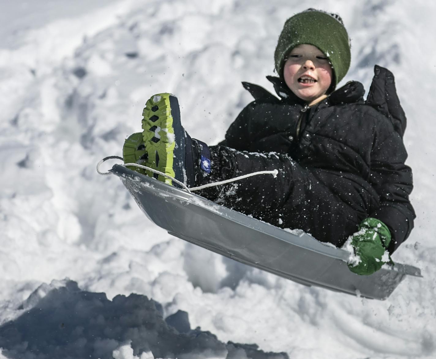 Brookston Melody, 8, gets some air on the hill in Gold Medal Park in Burnsville, Minn., Sunday, March 10, 2019 after a winter storm dumped more than a foot of snow in parts of the Upper Midwest. (Richard Tsong-Taatarii/Star Tribune via AP)