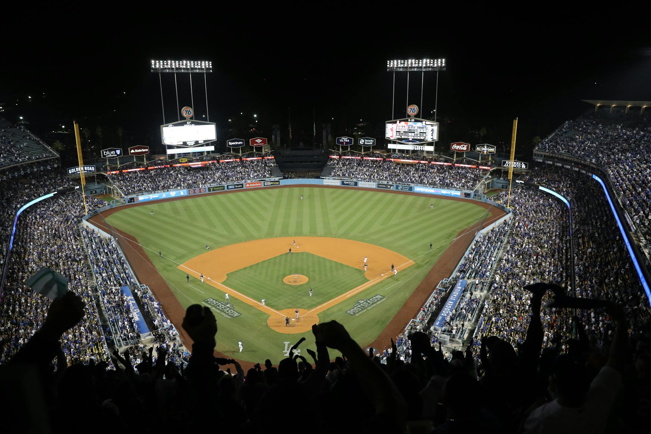 FILE — Los Angeles Dodgers fans react during Game 5 of the National League Championship Series against the Atlanta Braves at Dodger Stadium in Los Angeles, Oct. 21, 2021. Dodger Stadium is the home to the seven-time world champion Los Angeles Dodgers. But in the 1950s, the land around it belonged to families who are now seeking reparations for what they lost. (Meg Oliphant/The New York Times)