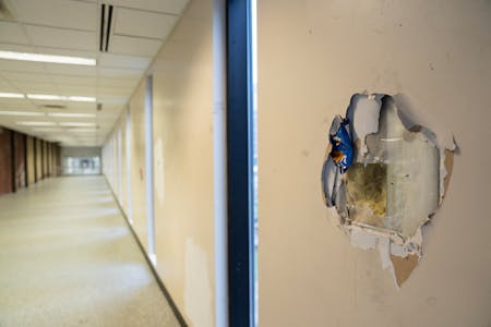 A hole in the wall of a downtown St. Paul skyway sits in disrepair in late 2023. City officials said administrative fines could be used to enforce bui