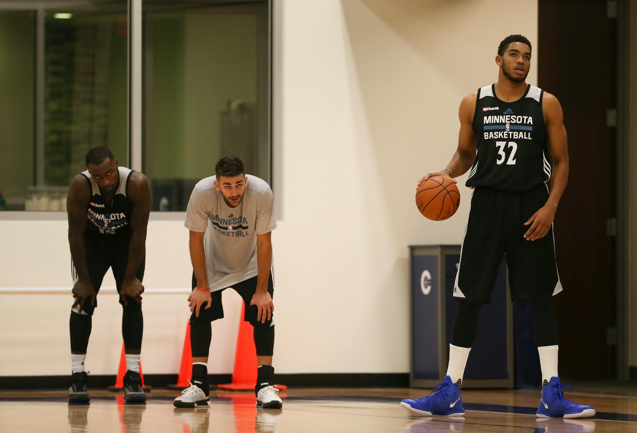 Wolves center Karl-Anthony Towns, right, with guard Ricky Rubio and forward Shabazz Muhammad, left, during the team's first practice Tuesday evening.