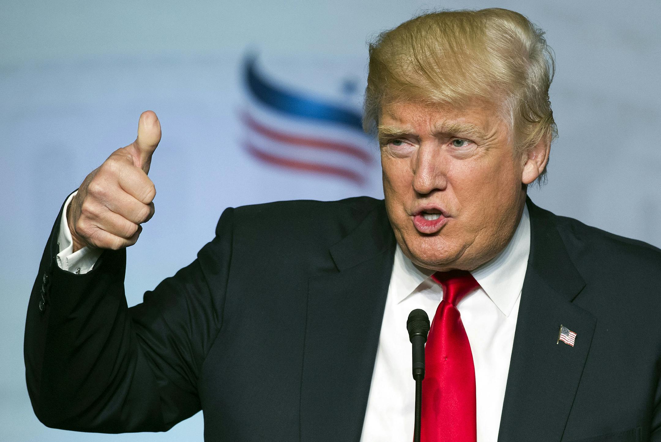 FILE - In this June 10, 2016 file photo, Republican presidential candidate Donald Trump gives a thumbs-up while addressing the Faith and Freedom Coalition's Road to Majority Conference in Washington. Trump will deliver a speech outlining his trade policies on June 28, a speech that is sure to underscore the stark differences between his approach and that of Democratic rival Hillary Clinton when it comes to handling the economy. Trump favors big tax cuts that mainly would help the rich. Clinton w