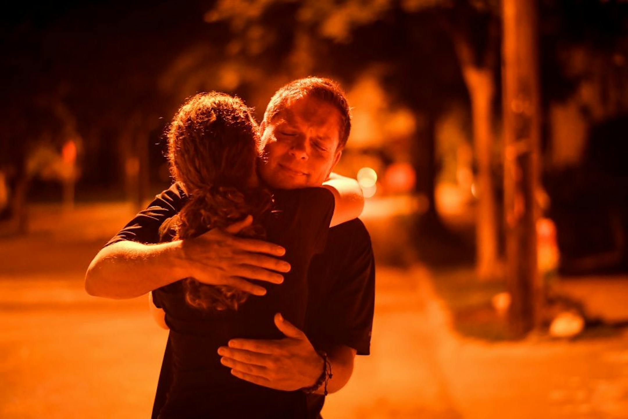 Don Damond comforted friend and neighbor Jenelle Masterson during a candlelight vigil for Justine Damond Ruszczyk.