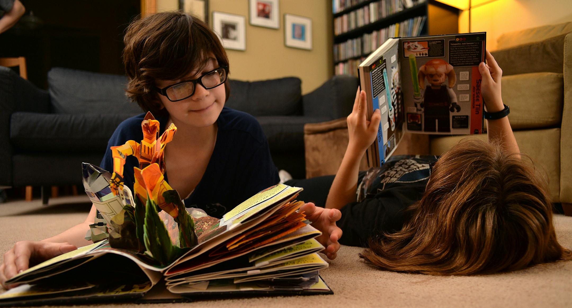 Sisters Olivia (left) and Maddie Novak indulge in reading two of their favorite Star Wars books under their Star Wars Christmas tree in their Maple Grove home. ] (SPECIAL TO THE STAR TRIBUNE/BRE McGEE) **Olivia Novak (left, 12), Maddie Novak (right, 10)