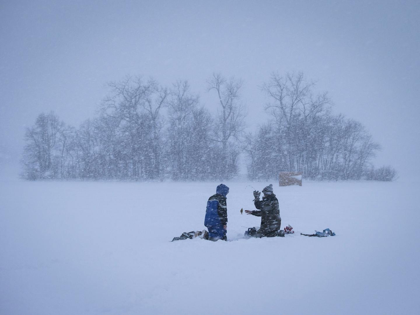 After an early release from school in Lakeville, Reid Saarela, 16 and Tyler Fietek ,16, went ice fishing at dusk on Crystal Lake during a snow storm on Tuesday, February 2, 2016 in Burnsville, Minn. ] RENEE JONES SCHNEIDER &#x2022; reneejones@startribune.com