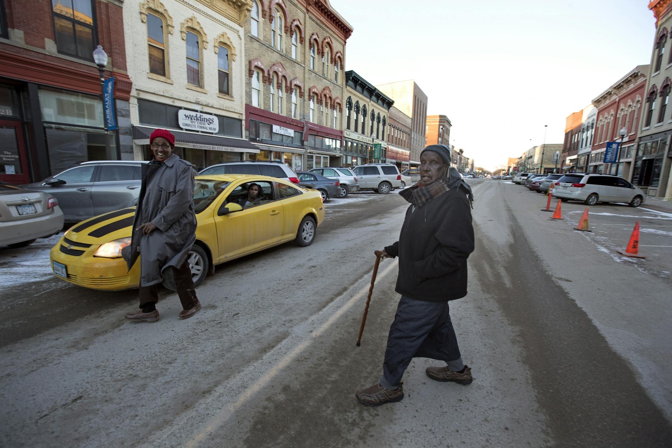 Hussen Ader, right, and his friend Nasir Abdullah walked across Central Avenue Wednesday Feb 1, 2017 in Faribault, MN.