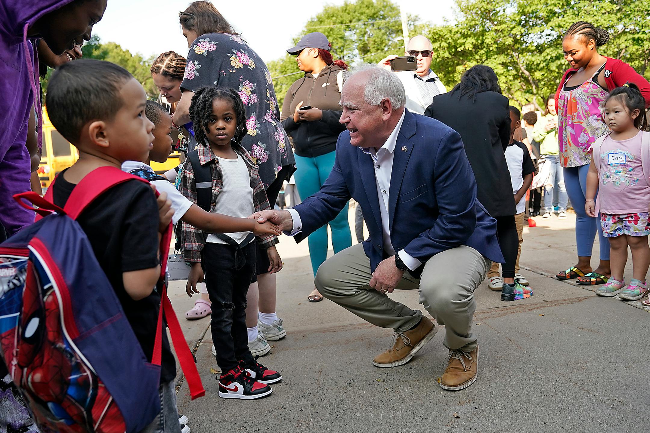 Governor Tim Walz got down on the level of the young students while visiting Zanewood Community School on the first day of school in Brooklyn Park.