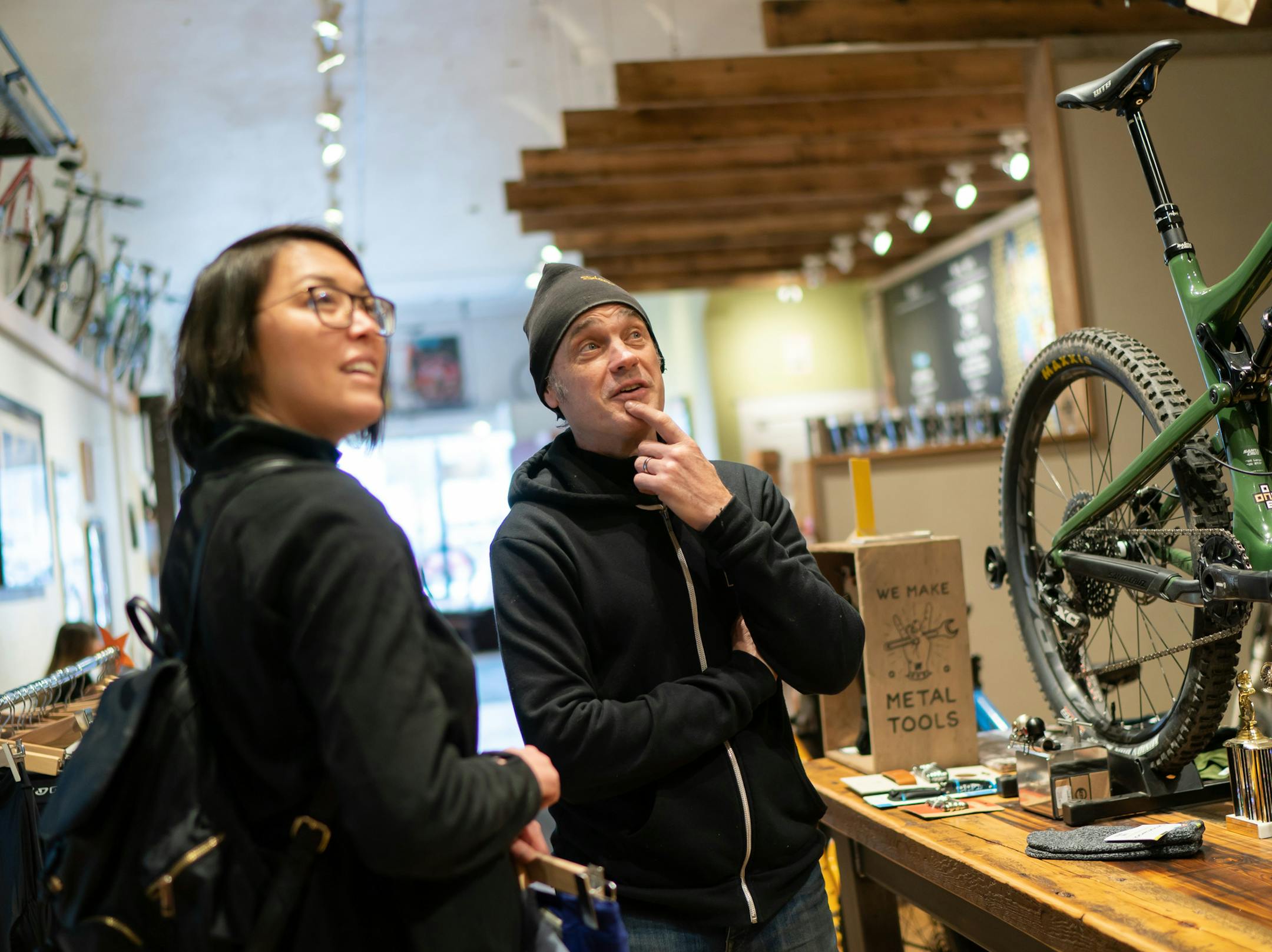 Gene Oberpriller talked with customer Heather McKeage in the shop. ] GLEN STUBBE &#xef; glen.stubbe@startribune.com Tuesday, December 11, 2018 Gene and Jennifer Oberpriller co-owners of One on One Bike Studio and Cafe in Minneapolis.