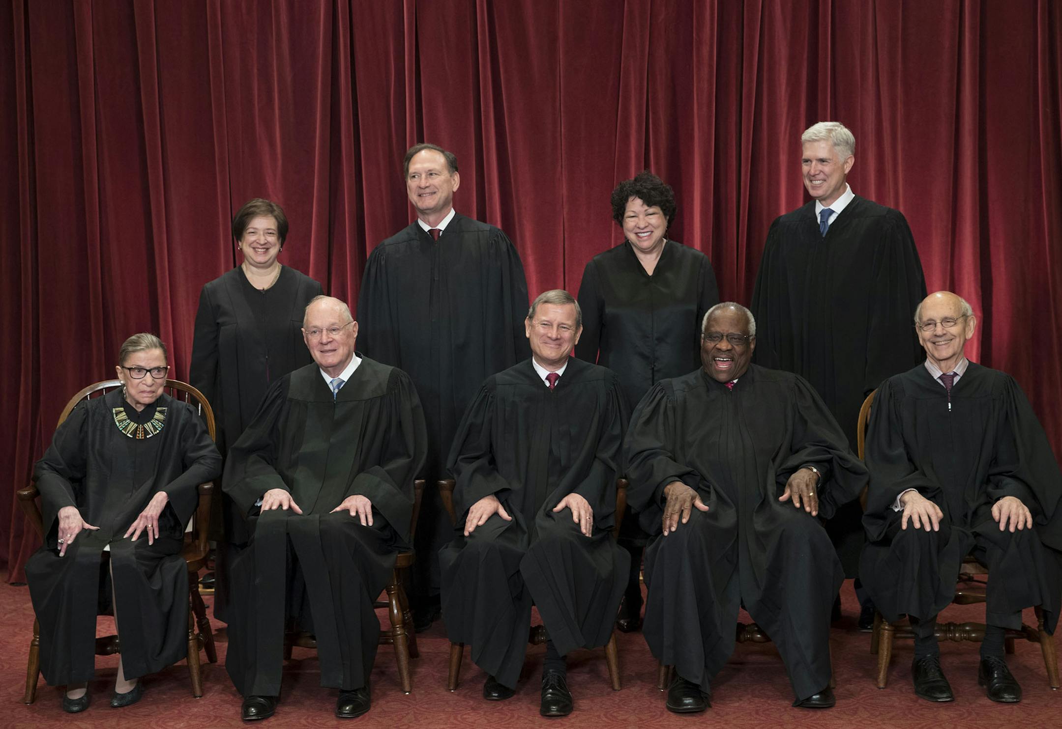 FILE - In this June 1, 2017, file photo, the justices of the U.S. Supreme Court gather for an official group portrait to include new Associate Justice Neil Gorsuch, top row, far right at the Supreme Court Building in Washington. Seated, front row, from left are, Associate Justice Ruth Bader Ginsburg, Associate Justice Anthony M. Kennedy, Chief Justice of the United States John Roberts, Associate Justice Clarence Thomas, and Associate Justice Stephen Breyer. Back row, standing, from left are, Ass