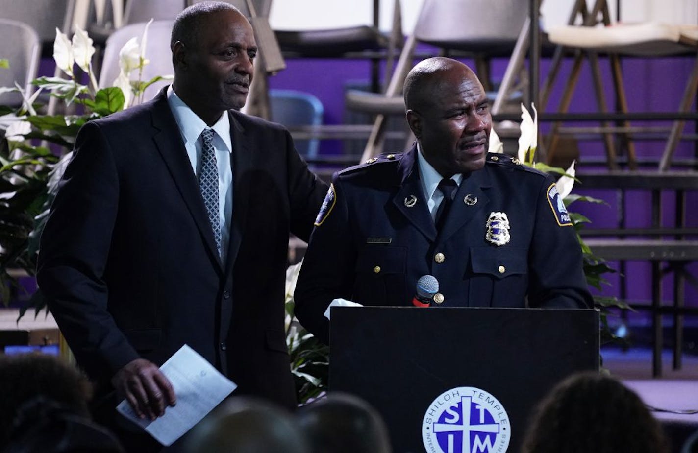 Al Flowers comforted Minneapolis police Sgt. Charles Adams as he became emotional speaking about his friend Ron Edwards during Edwards' funeral service Saturday.