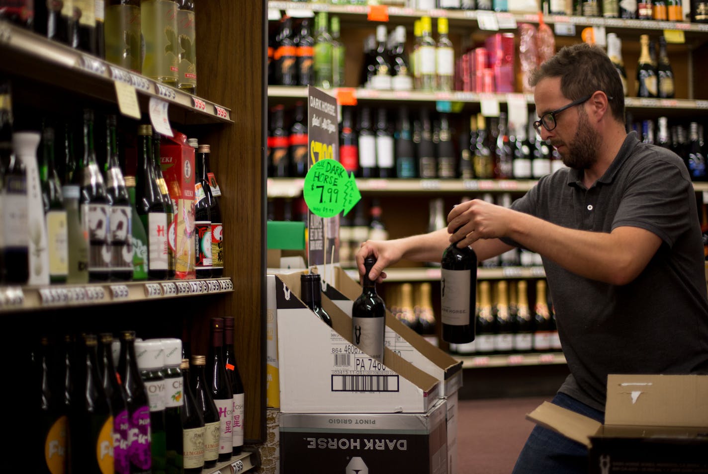 Andy Olson, a Sharrett's employee, restocks newly delivered wine. ] ALEX KORMANN &#x2022; alex.kormann@startribune.com It has been a year since Minnesota began to allow the sale of alcohol on Sunday. Most liquor stores operate on limited hours on Sunday. Sharrett's Liquor Store on University Ave is open 11AM-4PM on Sundays. The employees say being open on Sunday comes in handy every so often. When there's a slow Saturday it helps the store to make up for sales and turn a profitable weekend.