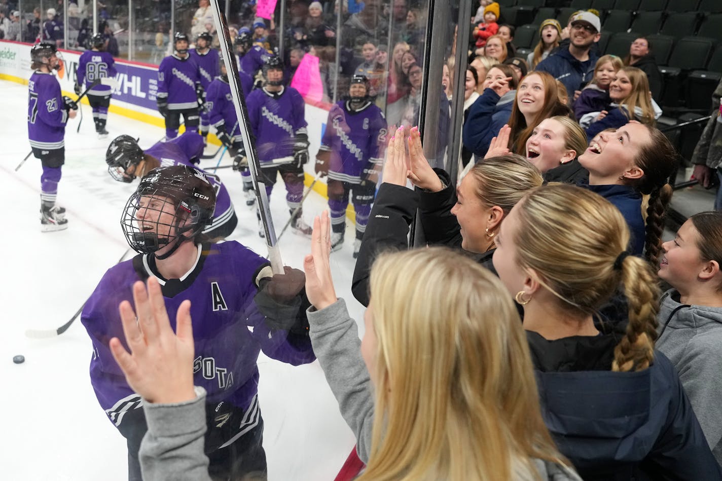 Minnesota forward Kelly Pannek (12) flipped a puck up over the glass to members of the Crookston High School girls varsity hockey team as they came to watch the first home game of the brand new women's professional hockey league (PWHL) as Minnesota faced off against Montreal Saturday, Jan. 6, 2024 at the Xcel Energy Center in St. Paul, Minn. ] ANTHONY SOUFFLE • anthony.souffle@startribune.com