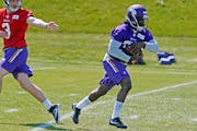 Minnesota Vikings rookie running back Dalvin Cook, right, takes a handoff from quarterback Wes Lunt during the NFL football team's rookies minicamp Fr