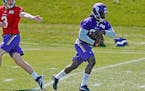 Minnesota Vikings rookie running back Dalvin Cook, right, takes a handoff from quarterback Wes Lunt during the NFL football team's rookies minicamp Fr