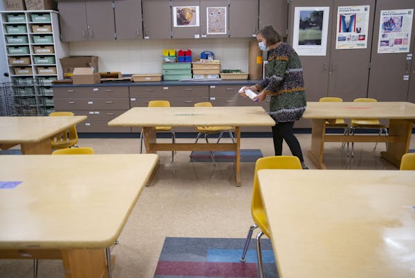 Sophie Gray Spehar disinfected each table in her art classroom on Monday at Duluth's Piedmont Elementary School on Sept. 21. Duluth schools will soon 