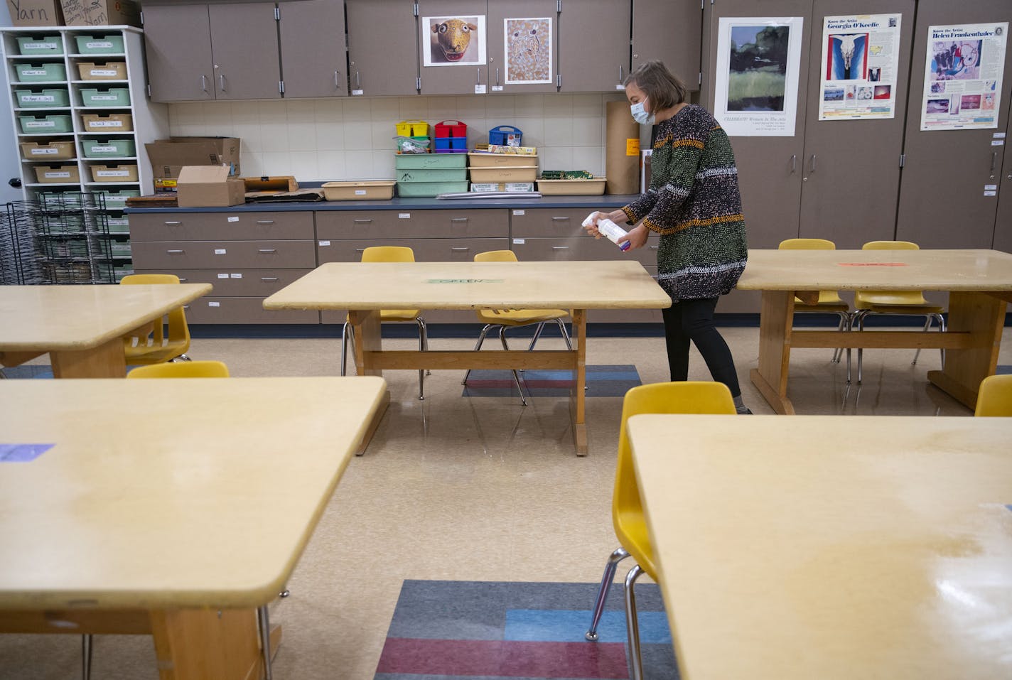 Sophie Gray Spehar disinfected each table in her art classroom on Monday at Duluth's Piedmont Elementary School on Sept. 21. Duluth schools will soon return to all-virtual learning and sports and activities will be "paused" until December as COVID-19 spreads faster than ever. ALEX KORMANN • alex.kormann@startribune.com