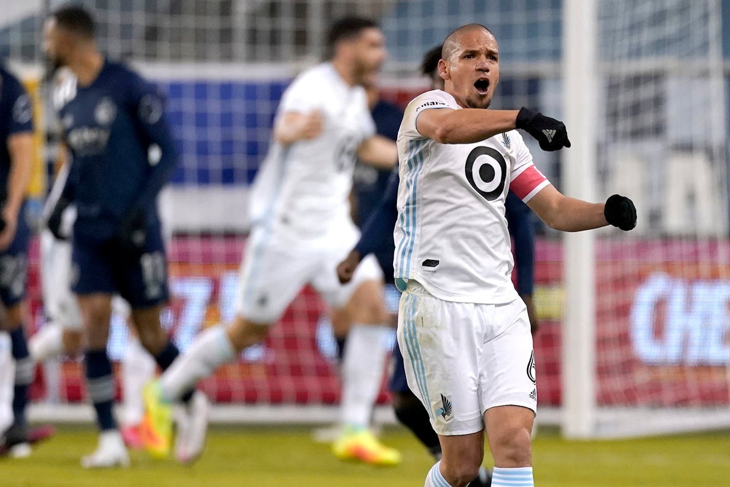 Minnesota United midfielder Osvaldo Alonso (6) celebrates after a goal by Bakaye Dibassy during the first half of the team's MLS soccer match against Sporting Kansas City on Thursday, Dec. 3, 2020, Kansas City, Kan. (AP Photo/Charlie Riedel)