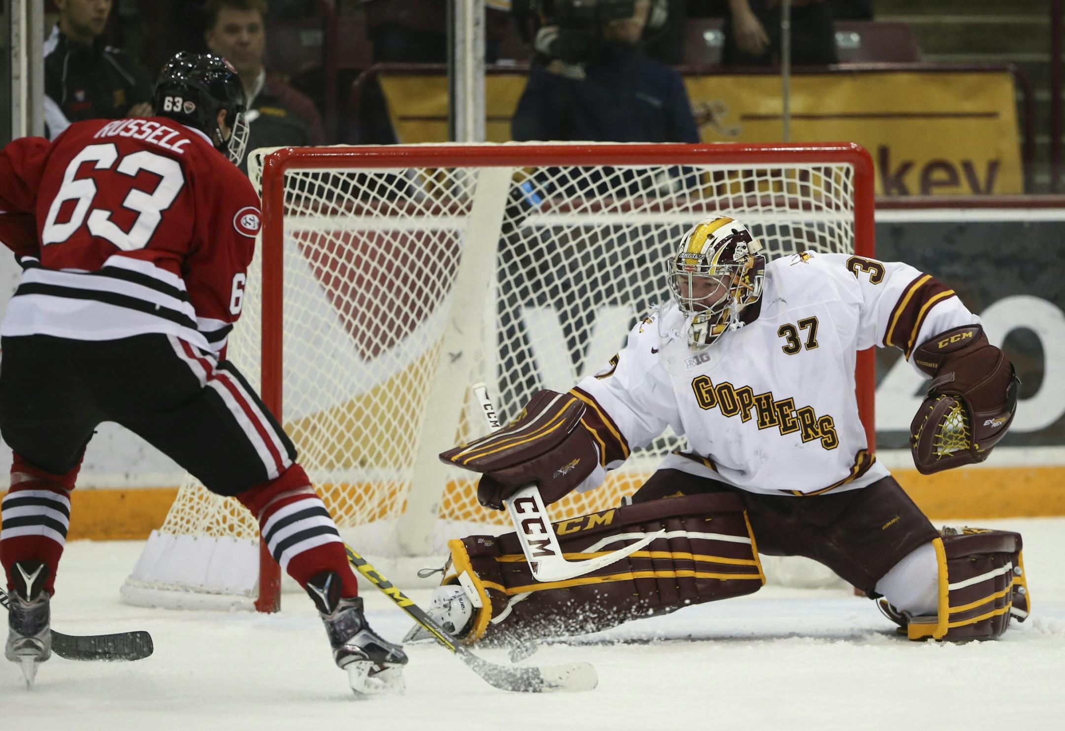 St. Cloud forward Patrick Russell (63) slapped a rebound past University of Minnesota goalie Eric Schierhorn (37) for the Huskies' fifth goal of the game while on the power play in the second period Sunday night.