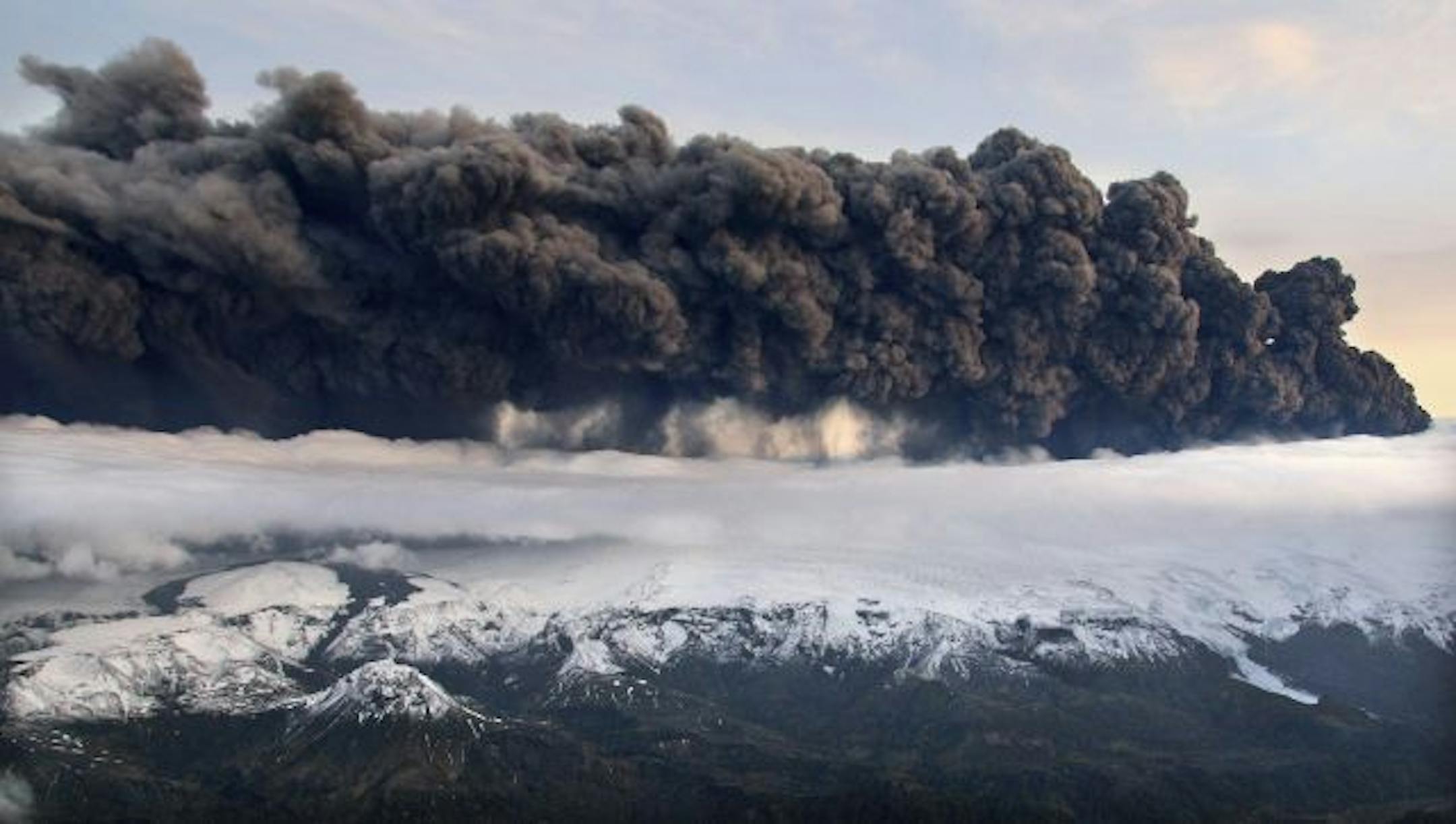 Smoke and steam hangs over the volcano under the Eyjafjallajokull glacier in Iceland, Wednesday April 14, 2010, which has erupted for the second time in less than a month, melting ice, shooting smoke and steam into the air and forcing hundreds of people to flee rising floodwaters. Volcanic ash drifting across the Atlantic forced the cancellation of flights in Britain and disrupted air traffic across northern Europe, stranding thousands of passengers. Flights in and out of London Heathrow, Europe