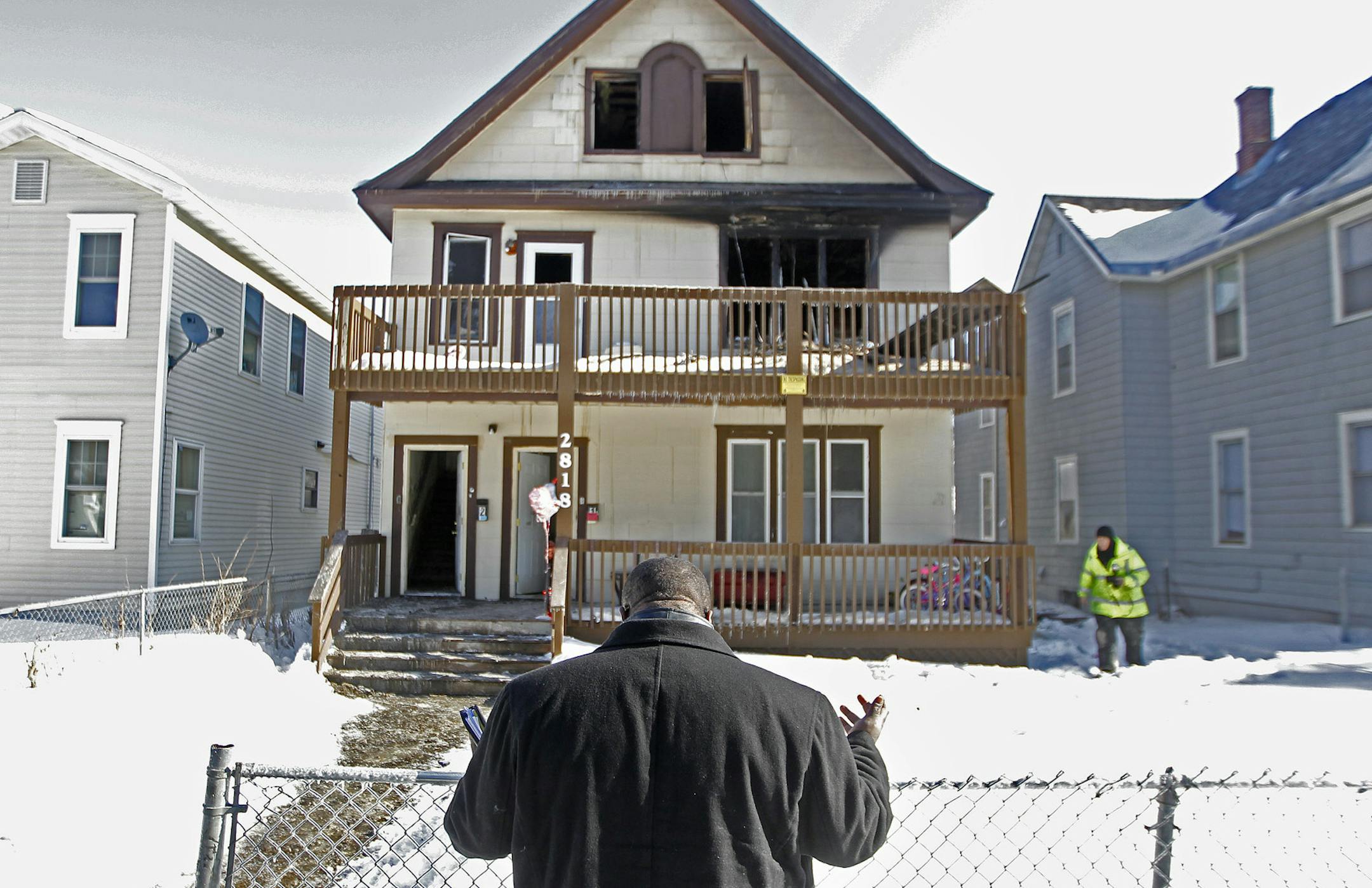 Pastor Harding N. Smith prayed in front of the home where a fire broke out early Friday, February 14, 2014 in Minneapolis, MN. Five children were killed in the blaze. (ELIZABETH FLORES/STAR TRIBUNE) ELIZABETH FLORES • eflores@startribune.com